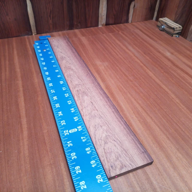Fingerboard Blanks 91 Craft your next masterpiece with this Honduran Rosewood blank, perfect for acoustic instruments. With a beautiful rift sawn pattern, it offers stunning aesthetics and superb tone. Ideal for luthiers seeking quality materials to create guitars that deliver rich, vibrant sound. Its durable nature ensures longevity, making every strum a delight and your craftsmanship truly shine. It is a Honduran Rosewood Acoustic Rift Sawn fingerboard blank with dimensions of 20.2 x 2.6 x 0.4 inches.