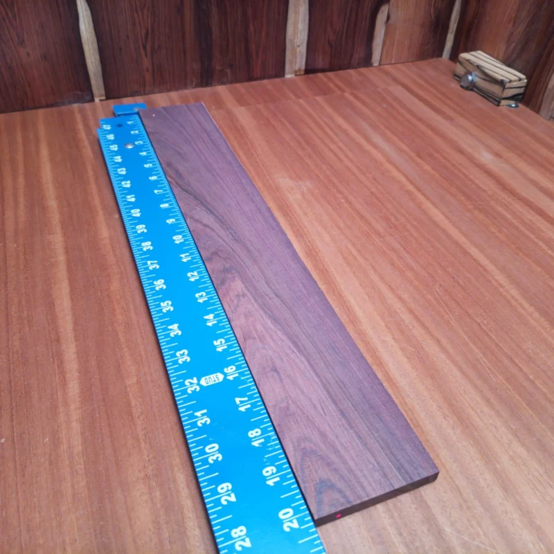 Explore the vibrancy of Honduran Rosewood with this rift sawn acoustic blank. Perfect for luthiers looking to create a rich, warm sound, this versatile wood enhances both aesthetics and tone. Its light weight facilitates easy handling while the fine grain structure ensures durability and beauty in your next instrument. Elevate your craft and impress musicians with premium quality sound that stands the test of time. It is a Honduran Rosewood Acoustic Rift Sawn fingerboard blank with dimensions of 20.1 x 3.1 x 0.4 inches.