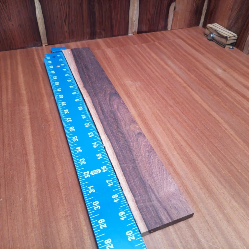 Fingerboard Blanks 148 Unlock your creativity with this Honduran Rosewood fingerboard blank, perfect for building premium acoustic instruments. Its beautiful grain and rich tone produce an upscale sound. Ideal for luthiers, this high-quality material offers durability and character, ensuring your next project stands out. Elevate your craft with a touch of elegance from this remarkable wood! It is a Honduran Rosewood Acoustic Rift Sawn fingerboard blank with dimensions of 20.0 x 2.8 x 0.4 inches.