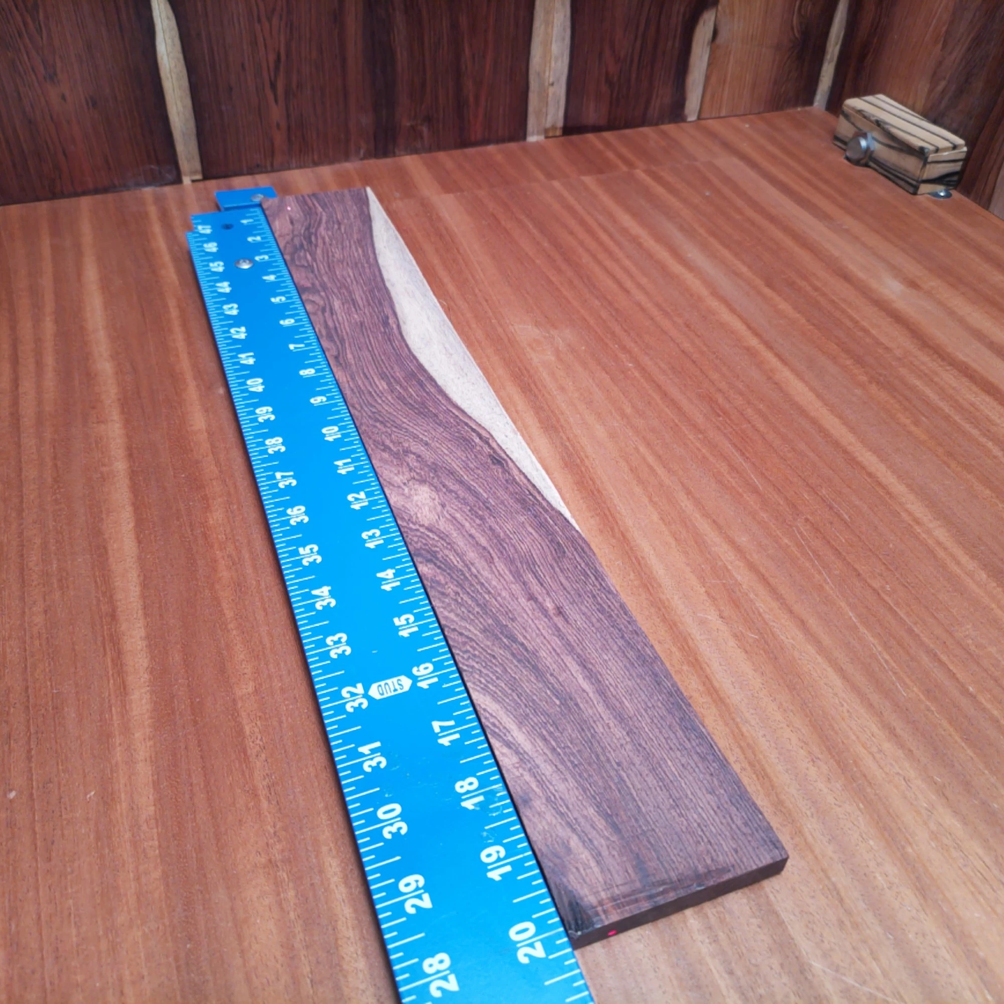 Honduran Rosewood Acoustic Rift Sawn Fingerboard Blank 0.4" X 2.8" X 20.1" - HRAFBR000602 1 This fingerboard blank made from Honduran Rosewood is perfect for your next acoustic project. With its rich color and beautiful grain, it enhances both aesthetics and sound quality. Designed for luthiers, this rift sawn wood offers superior stability and resonance, making it a great addition to any instrument. Craft with confidence and elevate your guitar's performance with this excellent choice for fingerboards. It is a Honduran Rosewood Acoustic Rift Sawn fingerboard blank with dimensions of 20.1 x 2.8 x 0.4 inches.
