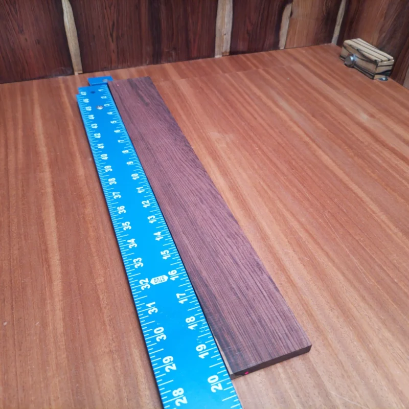 Fingerboard Blanks 94 Transform your luthier creations with this high-quality Honduran Rosewood blank. Ideal for acoustic guitars, its density ensures a sturdy foundation while enhancing tonal warmth and resonance. Whether you're crafting a new project or making repairs, this fingerboard blank will definitely impress with its rich color and character. Add style and substance to your builds and enjoy the natural beauty with every strum. It is a Honduran Rosewood Acoustic Rift Sawn fingerboard blank with dimensions of 19.9 x 2.7 x 0.4 inches.