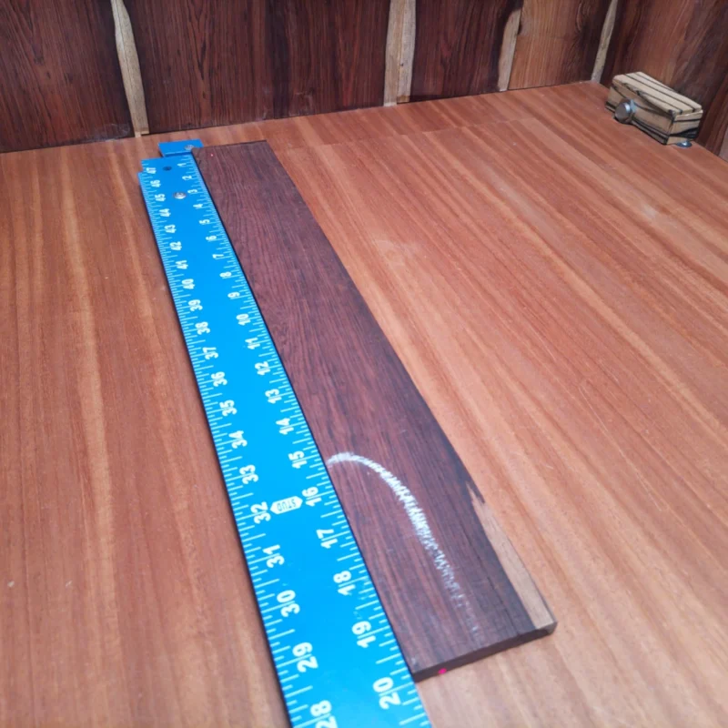 Transform your luthier creations with this high-quality Honduran Rosewood blank. Ideal for acoustic guitars, its density ensures a sturdy foundation while enhancing tonal warmth and resonance. Whether you're crafting a new project or making repairs, this fingerboard blank will definitely impress with its rich color and character. Add style and substance to your builds and enjoy the natural beauty with every strum. It is a Honduran Rosewood Acoustic Rift Sawn fingerboard blank with dimensions of 19.9 x 2.7 x 0.4 inches.