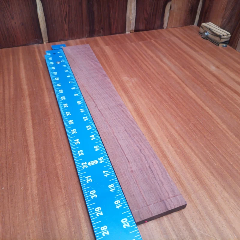 Honduran Rosewood Acoustic Rift Sawn Fingerboard Blank 0.4" X 2.9" X 20.2" - HRAFBR000618 3 Elevate your next acoustic project with this stunning rift sawn Honduran Rosewood fingerboards blank. Perfect for luthiers seeking a rich, warm sound, it offers exceptional tonal qualities and stunning aesthetics. This versatile blank is ideal for shaping into the perfect neck, giving you the stability and resonance that professional quality demands. Upgrade your builds with this attractive and durable Rosewood option today! It is a Honduran Rosewood Acoustic Rift Sawn fingerboard blank with dimensions of 20.2 x 2.9 x 0.4 inches.