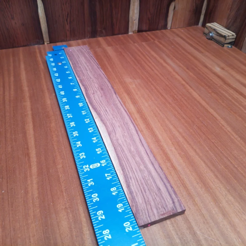 Fingerboard Blanks 84 Elevate your luthiery with this stunning Honduran Rosewood blank, perfect for creating lush acoustic soundboards. With a rift-sawn profile, this wood boasts stability and an exquisite tonal quality that will bring your instruments to life. Ideal for guitar builders and seasoned craftsmen alike, this blank is waiting for your creative touch. Get ready to impress with a unique piece that combines beauty and functionality. It is a Honduran Rosewood Acoustic Rift Sawn fingerboard blank with dimensions of 20.3 x 2.5 x 0.4 inches.