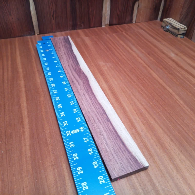 Honduran Rosewood Acoustic Rift Sawn Fingerboard Blank 0.4" X 2.5" X 20.3" - HRAFBR000639 3 Elevate your luthiery with this stunning Honduran Rosewood blank, perfect for creating lush acoustic soundboards. With a rift-sawn profile, this wood boasts stability and an exquisite tonal quality that will bring your instruments to life. Ideal for guitar builders and seasoned craftsmen alike, this blank is waiting for your creative touch. Get ready to impress with a unique piece that combines beauty and functionality. It is a Honduran Rosewood Acoustic Rift Sawn fingerboard blank with dimensions of 20.3 x 2.5 x 0.4 inches.
