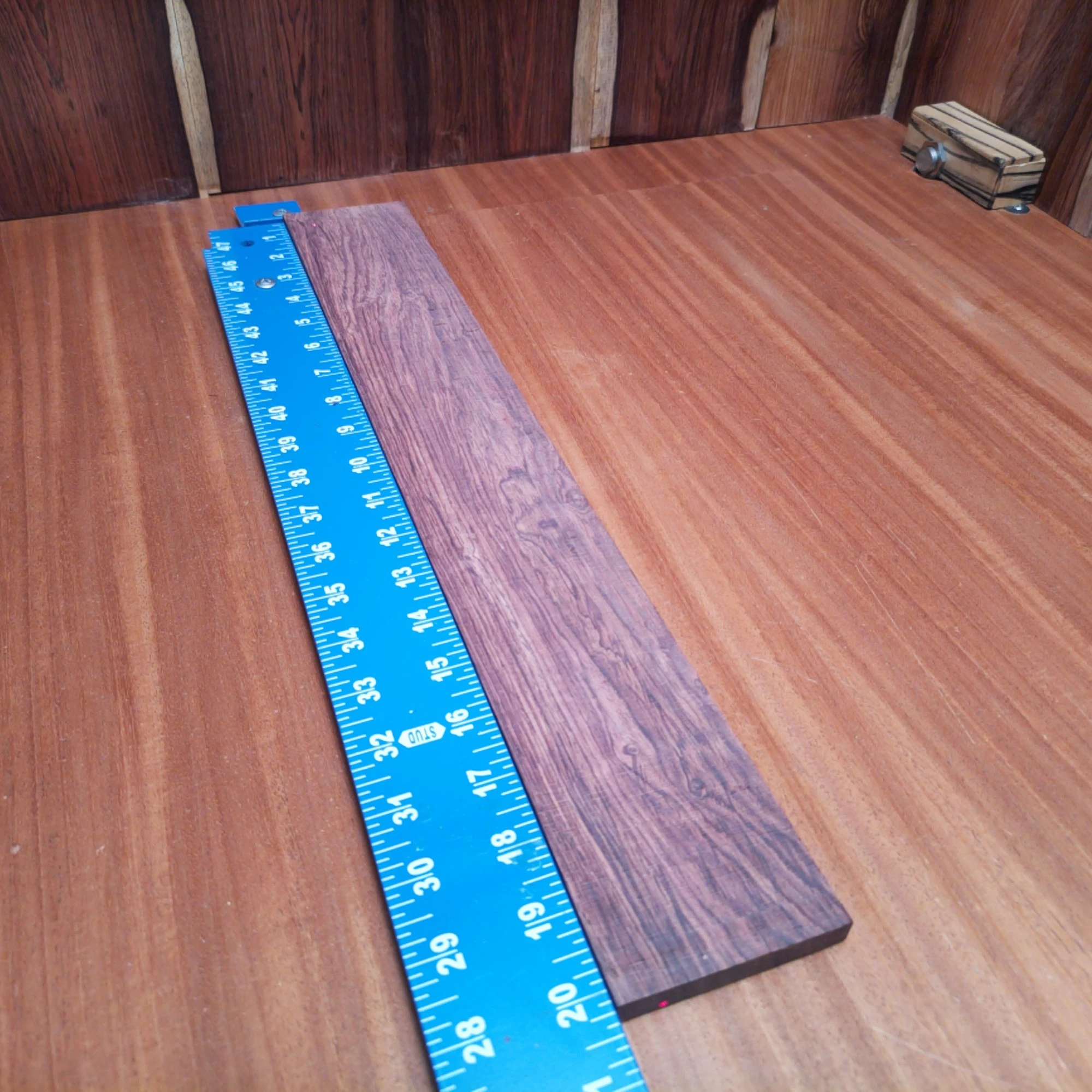 Honduran Rosewood Acoustic Rift Sawn Fingerboard Blank 0.4" X 2.9" X 20.3" - HRAFBR000645 1 This Honduran rosewood fingerboard blank is perfect for crafting high-quality acoustic instruments. With its beautiful grain and warm tonal qualities, this rift-sawn piece offers luthiers a reliable source for stunning fingerboards. Its dimensions make it versatile enough for various projects, enhancing playability and aesthetic value. Elevate your creations with this premium wood, designed for both performance and durability. It is a Honduran Rosewood Acoustic Rift Sawn fingerboard blank with dimensions of 20.3 x 2.9 x 0.4 inches.