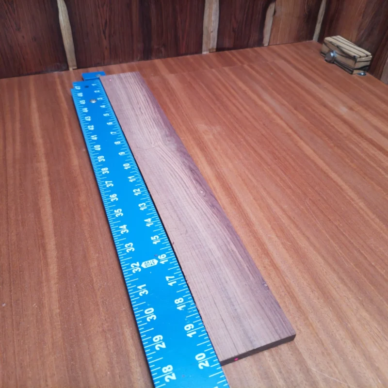 Fingerboard Blanks 127 Elevate your craft with this Honduran Rosewood blank, perfect for luthiers crafting acoustic instruments. Its striking grain and rich tone provide both aesthetic appeal and superior sound quality. Create stunning guitars that resonate beautifully while standing out visually. This versatile blank offers ample size for various projects, ensuring you can bring your musical visions to life with ease and precision. It is a Honduran Rosewood Acoustic Rift Sawn fingerboard blank with dimensions of 20.2 x 2.7 x 0.4 inches.