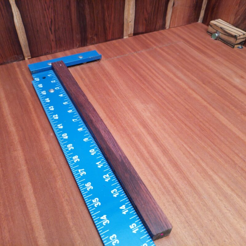 Honduran Rosewood brings sophistication to your life! Whether you opt for luxury drawer pulls or custom cutting boards, your home will exude elegance. Handcrafted cocktail stirrers add a dash of style, while bespoke game pieces keep family night exciting! And don't forget to adorn your walls with wooden picture frames that showcase your best moments or a sculptural desk ornament that says, 'look at me!' This piece of Honduran Rosewood measures 0.9 inches by 0.9 inches by 15.8 inches, offering a high-quality option for a variety of woodworking projects.