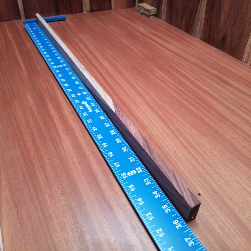 With a slender profile, Honduran Rosewood helps forge a world of luxurious guitar fretboards, chic knife handles, and custom drawer pulls. Imagine crafting eye-catching picture frames or even elegant bookmarks that make boring stories look good! You're not just crafting wood; you're creating stories, art, and a little sprinkle of extravagance with every twist and turn of your project! This piece of Honduran Rosewood measures 0.5 inches by 1.2 inches by 36.0 inches, offering a high-quality option for a variety of woodworking projects.