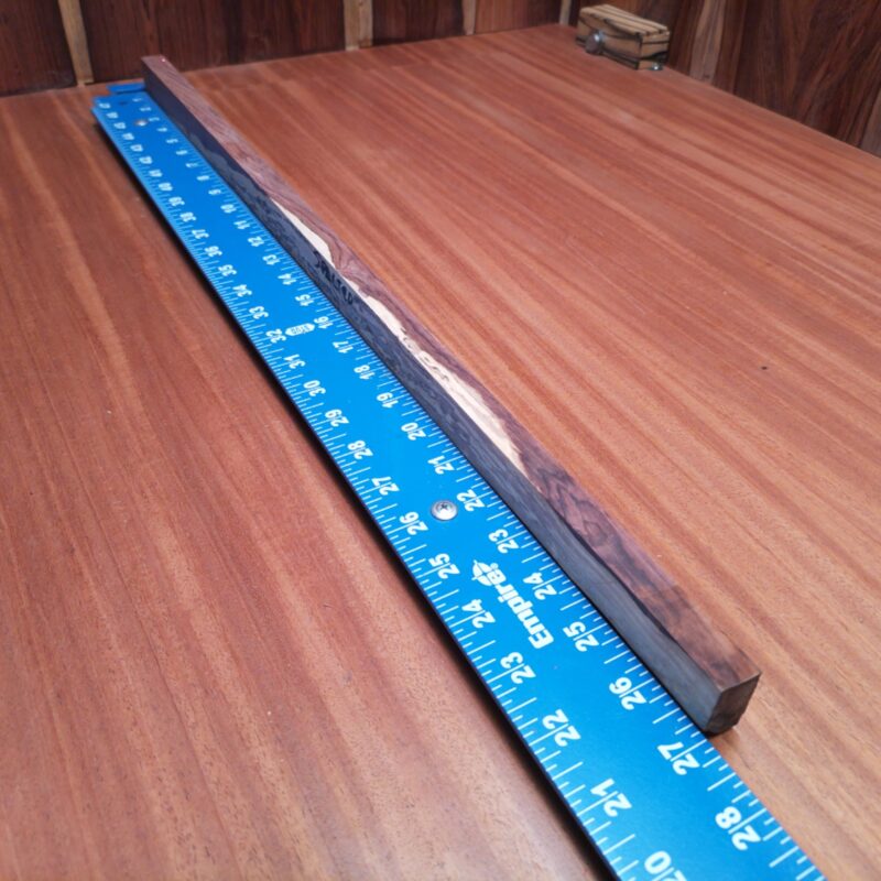 Introducing the Honduran Rosewood G2: a versatile masterpiece! With it, you could carve out a luxury guitar neck, sculpt a stunning art piece, or even create one-of-a-kind chopsticks. Maybe you want it for decorative bookmarks or that fancy minimalist desk organizer? The possibilities are endless, just like my love for wood! This piece of Honduran Rosewood measures 0.7 inches by 1.2 inches by 26.8 inches, offering a high-quality option for a variety of woodworking projects.
