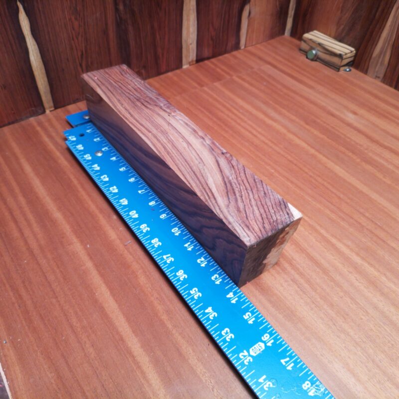 Honduran Rosewood G1 offers endless possibilities! Transform it into a custom guitar pick or elegant furniture handles. Need a high-end decorative piece? Consider a unique napkin holder or luxurious coasters! With so much potential, it’s not just wood; it’s a crafting adventure waiting to happen! This piece of Honduran Rosewood measures 3.1 inches by 2.3 inches by 13.6 inches, offering a high-quality option for a variety of woodworking projects.