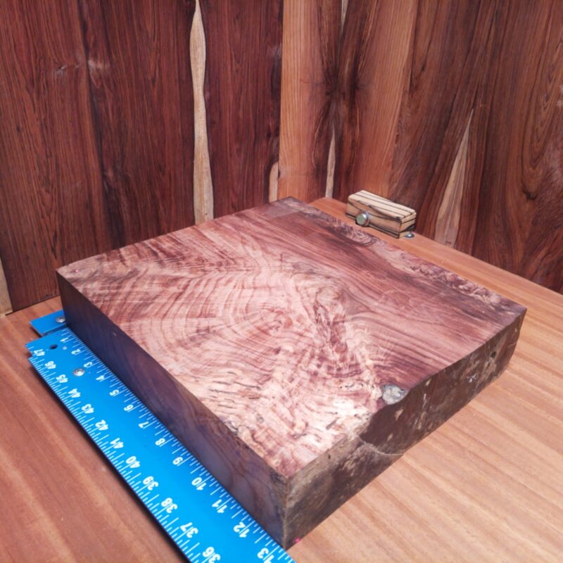 Honduran Rosewood 2.7" X 12.8" X 13.3" Wood Blank for Woodworking Projects - HRDL001154 6 Imagine turning this Honduran Rosewood into a luxury serving board or a stylish phone stand. You could go all out and sculpt an artistic wizard figurine, or keep it functional with a high-end knife block. With this beautiful wood, even your coasters will become works of art, because why should your drinks be the only ones getting the royal treatment? This piece of Honduran Rosewood measures 2.7 inches by 12.8 inches by 13.3 inches, offering a high-quality option for a variety of woodworking projects.