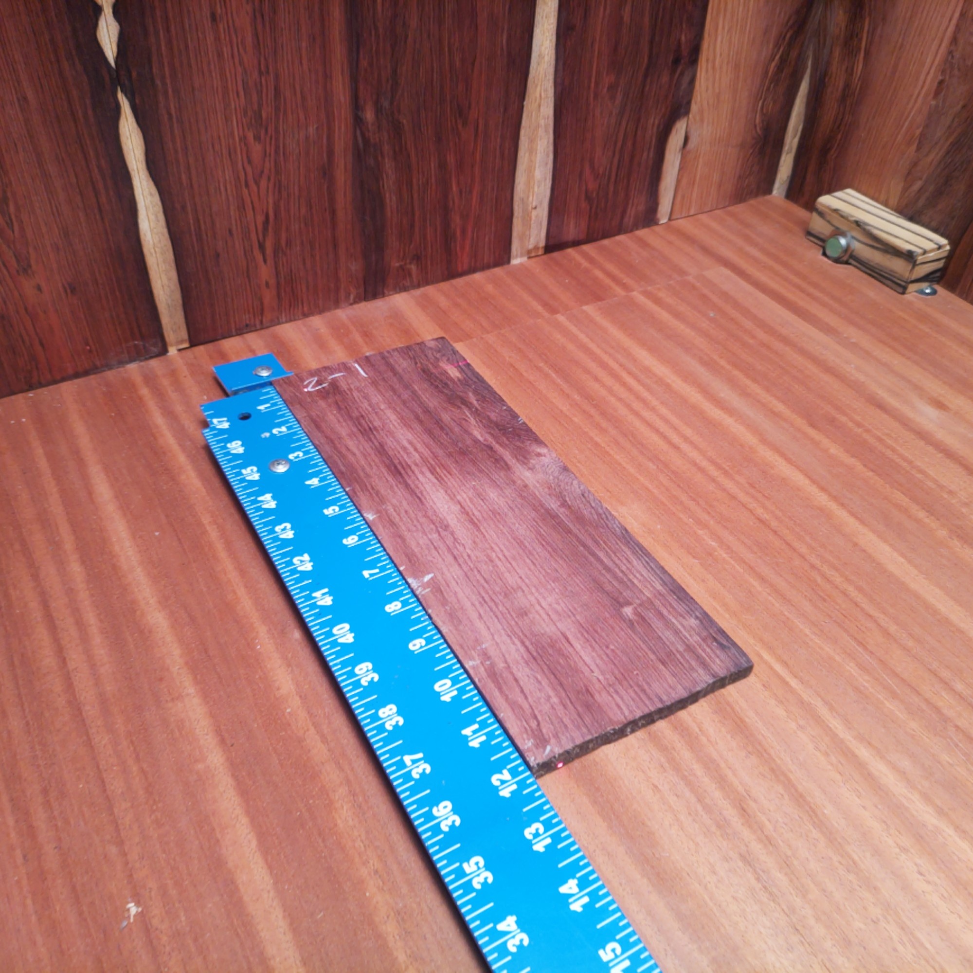Honduran Rosewood 0.2" X 4.6" X 11.9" Wood Blank for Woodworking Projects - HRDL001165 1 With a dash of Honduran Rosewood, you can craft luxurious coasters and high-end guitar neck bindings while flaunting custom knife handles! Get creative with decorative wall art and make those boring keychains something to remember! It’s like popping confetti at a woodworkers' party—everyone loves it! This piece of Honduran Rosewood measures 0.2 inches by 4.6 inches by 11.9 inches, offering a high-quality option for a variety of woodworking projects.