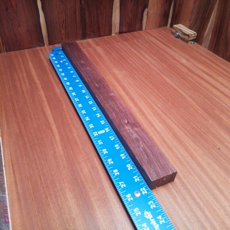 Unleash your creativity with this splendid Honduran Rosewood! Whether you're crafting luxury pens or artistic picture frames, the possibilities are endless! Picture bespoke wooden spoons that make your soup taste fancier, or elegant candle holders that make your room feel like a five-star hotel. Just don't forget to add those unique curtain tiebacks to your collection! Who knew a piece of wood could bring so much joy? This piece of Honduran Rosewood measures 1.1 inches by 1.8 inches by 21.9 inches, offering a high-quality option for a variety of woodworking projects.