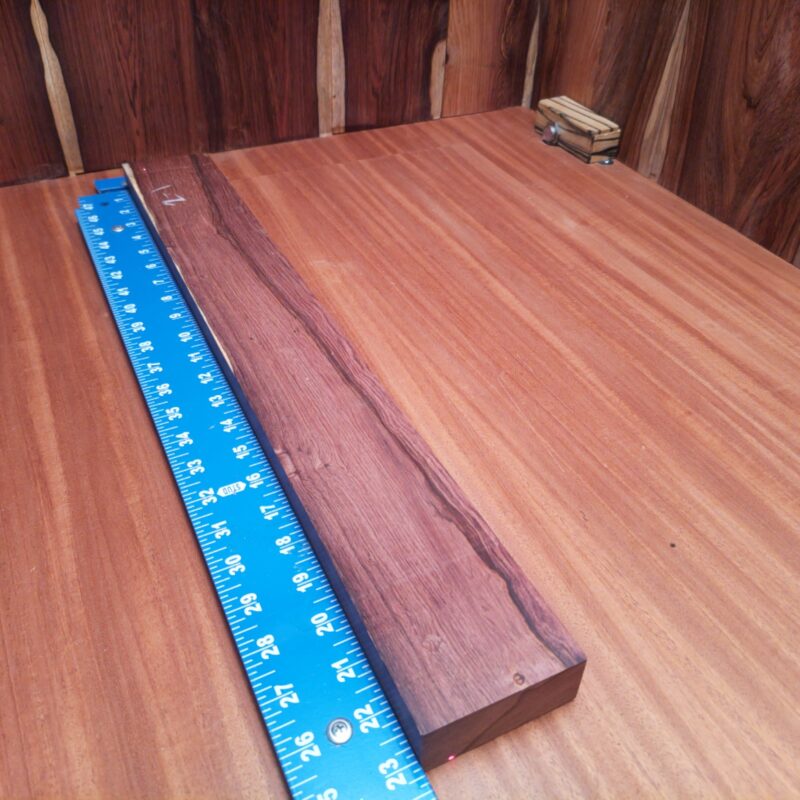 Dimensional Lumber 159 Imagine crafting a luxurious serving board while dreaming of elegant drawer pulls and chasing custom wine rack ideas. The possibilities of Honduran Rosewood are virtually endless! Picture stylish lamp stands bringing a cozy vibe alongside unique wine bottle holders and artistic sculpture bases—perfect for impressing guests while showing off your creative mastery! This piece of Honduran Rosewood measures 1.1 inches by 2.9 inches by 22.9 inches, offering a high-quality option for a variety of woodworking projects.