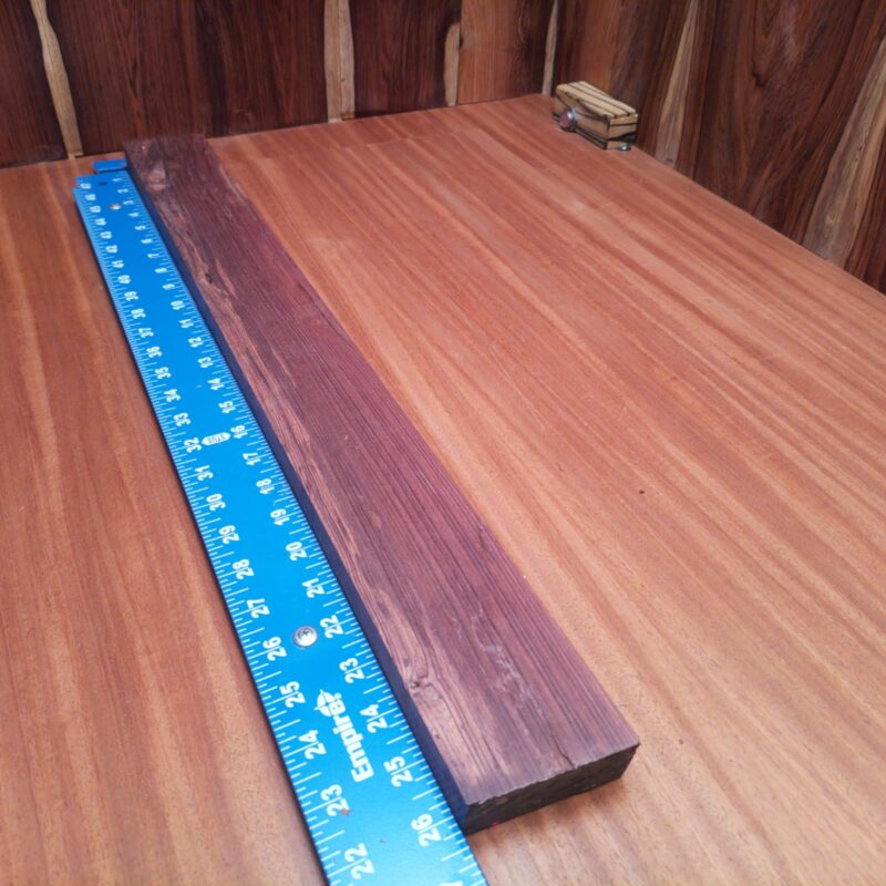 Honduran Rosewood 1.1" X 2.7" X 26.4" Wood Blank for Woodworking Projects - HRDL001185 6 Craft something luxurious with your Honduran Rosewood! From elegant coffee table legs to unique jewelry boxes, this versatile piece allows you to create high-end drawer pulls and charming picture frames with flair. If you ever wanted a knife handle that doubles as a conversation starter, you'll love this wood's charm! Get ready to unleash your inner artisan and turn your home into a gallery! This piece of Honduran Rosewood measures 1.1 inches by 2.7 inches by 26.4 inches, offering a high-quality option for a variety of woodworking projects.