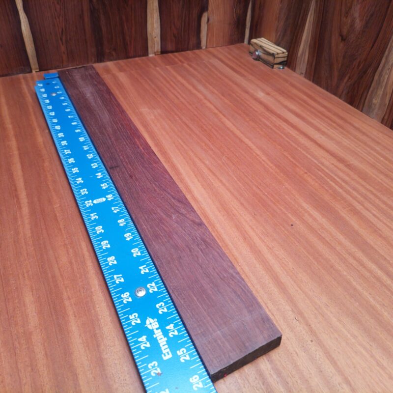 Honduran Rosewood 0.7" X 2.7" X 25.9" Wood Blank for Woodworking Projects - HRDL001186 6 With Honduran Rosewood, you can turn the mundane into the magnificent! Imagine crafting luxury guitar backs, unique picture frames, or even stunning wood sculptures that will make your friends swoon! Dive into artisanal treasures with stylish serving trays and custom drawer pulls that scream sophistication while secretly being practical. Who knew such a piece could create so much magic in your home? This piece of Honduran Rosewood measures 0.7 inches by 2.7 inches by 25.9 inches, offering a high-quality option for a variety of woodworking projects.