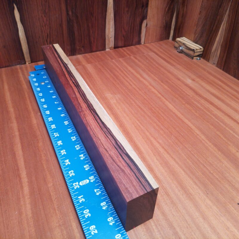 Honduran Rosewood brings class to your home! Create luxury drawer pulls, a custom guitar neck, or a unique serving platter that will have your guests asking for more. The beautiful grains can shape artistic photo frames and whimsical coasters, making everything feel high-end, even that spoon rest! With such versatile dimensions, furniture and decor options are plentiful, making this wood feel like a celebrity among its peers! This piece of Honduran Rosewood measures 1.7 inches by 2.8 inches by 19.6 inches, offering a high-quality option for a variety of woodworking projects.