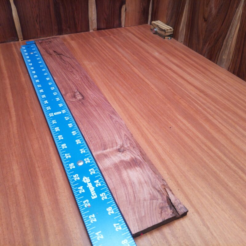 Dimensional Lumber 142 Discover the endless possibilities of Honduran Rosewood! Transform those splinters into high-end drawer pulls, ornate picture frames, or a luxurious charcuterie board that even your cheese can appreciate. Picture elegant bookends, rustic candle holders, and a unique set of custom guitar necks—perfect for all musicians with a flair for style! This piece of Honduran Rosewood measures 0.7 inches by 3.2 inches by 27.6 inches, offering a high-quality option for a variety of woodworking projects.