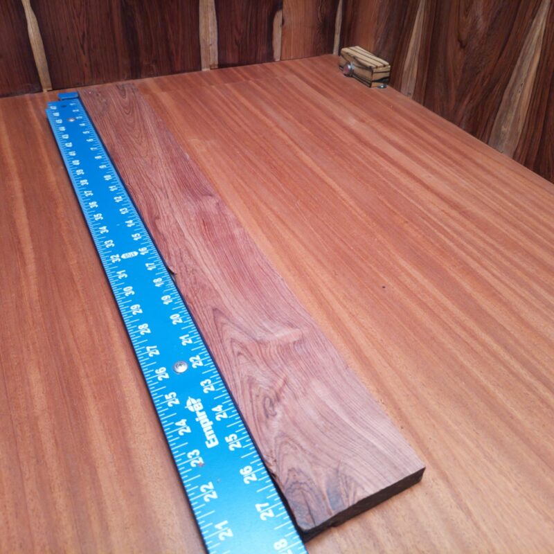 Honduran Rosewood 0.7" X 3.2" X 27.6" Wood Blank for Woodworking Projects - HRDL001188 6 Discover the endless possibilities of Honduran Rosewood! Transform those splinters into high-end drawer pulls, ornate picture frames, or a luxurious charcuterie board that even your cheese can appreciate. Picture elegant bookends, rustic candle holders, and a unique set of custom guitar necks—perfect for all musicians with a flair for style! This piece of Honduran Rosewood measures 0.7 inches by 3.2 inches by 27.6 inches, offering a high-quality option for a variety of woodworking projects.