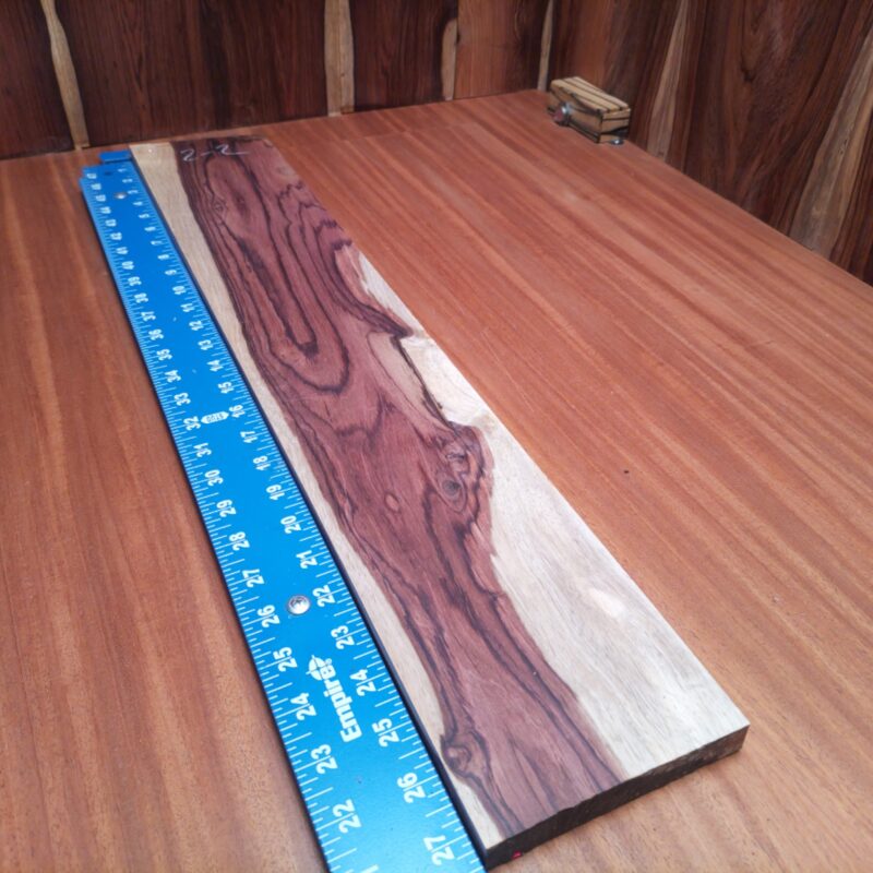 With Honduran Rosewood, transform your life into a luxury magnet! Create a stylish cutting board for gourmet meals, chic planter boxes bursting with greenery, or even elegant picture frames that showcase your best moments. Feeling artistic? Whip up some distinctive wall art or a unique souvenir box to impress friends. Just remember, wood loves to be loved – and this beauty will turn heads! This piece of Honduran Rosewood measures 0.7 inches by 4.7 inches by 26.9 inches, offering a high-quality option for a variety of woodworking projects.