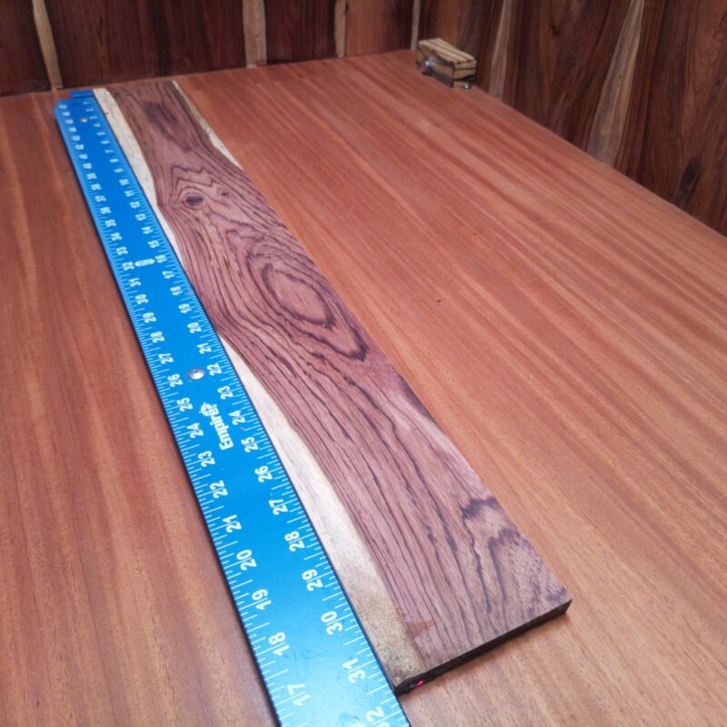 Dimensional Lumber 129 Looking to elevate your decor? Transform Honduran Rosewood into a custom guitar neck or a luxury serving tray! Whether you’re crafting sleek picture frames or elegant napkin holders, the only limit is your imagination—and your woodshop! Each piece is just waiting to become that high-end decorative touch you never knew you needed! This piece of Honduran Rosewood measures 0.5 inches by 3.8 inches by 31.6 inches, offering a high-quality option for a variety of woodworking projects.
