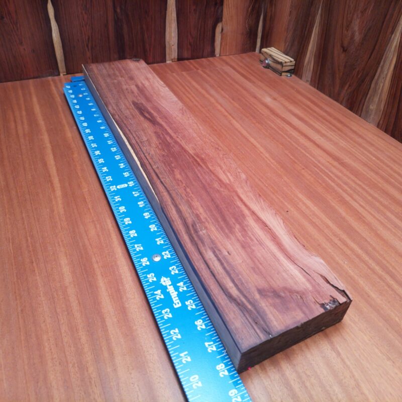 Honduran Rosewood 1.5" X 5.1" X 27.9" Wood Blank for Woodworking Projects - HRDL001216 6 Transform your Honduran Rosewood into a stunning customized guitar body, a unique jewelry box, or an elegant serving tray! With these luscious dimensions, your wood can be an artistic table centerpiece or stylish knife handle. Who knew such a versatile piece could make everything from rustic picture frames to bespoke drawer dividers? You'll have guests wondering if you hired a magician or a master woodworker! This piece of Honduran Rosewood measures 1.5 inches by 5.1 inches by 27.9 inches, offering a high-quality option for a variety of woodworking projects.