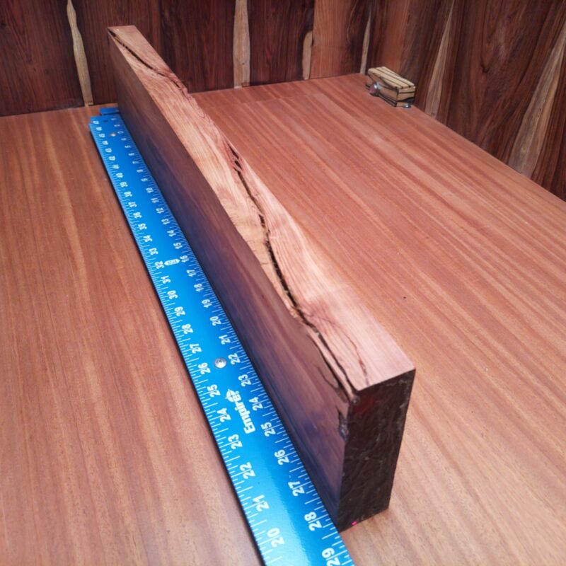 Honduran Rosewood 1.5" X 5.1" X 27.9" Wood Blank for Woodworking Projects - HRDL001216 7 Transform your Honduran Rosewood into a stunning customized guitar body, a unique jewelry box, or an elegant serving tray! With these luscious dimensions, your wood can be an artistic table centerpiece or stylish knife handle. Who knew such a versatile piece could make everything from rustic picture frames to bespoke drawer dividers? You'll have guests wondering if you hired a magician or a master woodworker! This piece of Honduran Rosewood measures 1.5 inches by 5.1 inches by 27.9 inches, offering a high-quality option for a variety of woodworking projects.