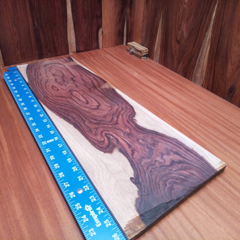 Honduran Rosewood 0.7" X 7.7" X 26.3" Wood Blank for Woodworking Projects - HRDL001226 6 Who knew a piece of wood could be so versatile? With Honduran Rosewood, you could whip up a custom guitar body, craft chic coasters, or finally build that stylish desk organizer you've been dreaming about! Perfect for anything from table legs to sophisticated wall art, this elegant wood can turn your creative ideas into luxurious reality – with a touch of whimsy, of course! This piece of Honduran Rosewood measures 0.7 inches by 7.7 inches by 26.3 inches, offering a high-quality option for a variety of woodworking projects.