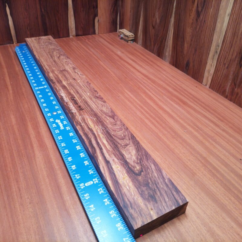 With just the right amount of charm and elegance, this Honduran Rosewood can be fashioned into a stunning cutting board, a luxurious jewelry box, or a unique wine rack. Imagine customizing it into high-end drawer fronts or an elegant plant stand to impress your guests. If it can hold kinks in your design, it can surely hold the weight of your wine bottles too! This piece of Honduran Rosewood measures 1.2 inches by 4.3 inches by 36.9 inches, offering a high-quality option for a variety of woodworking projects.