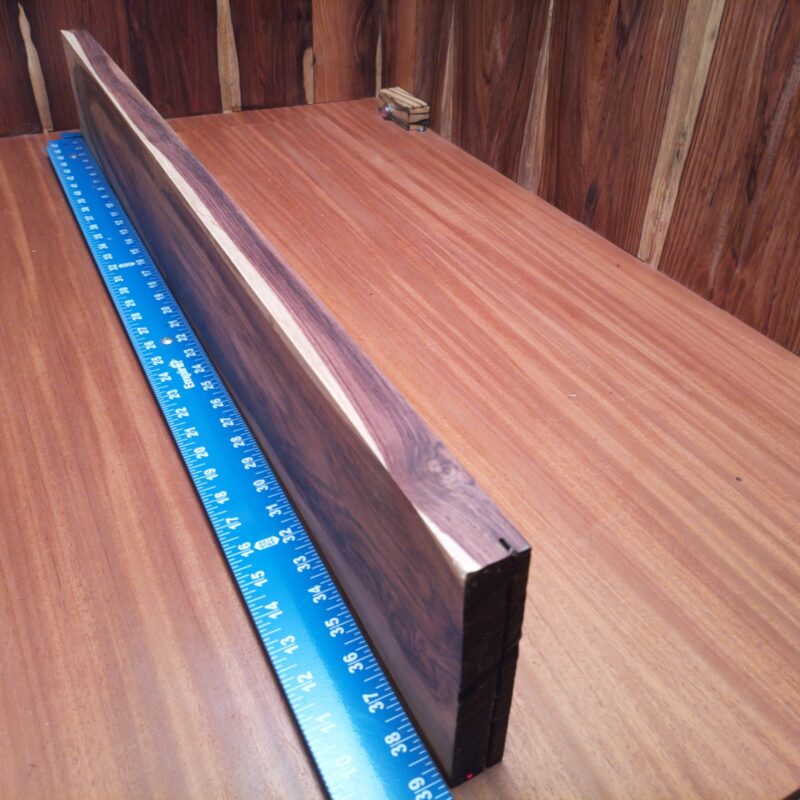 Honduran Rosewood 1.1" X 5.6" X 39.0" Wood Blank for Woodworking Projects - HRDL001235 5 With Honduran Rosewood G1, your decorative wall art will truly shine like the sun! Picture this: a unique charcuterie board that’s so beautiful even the cheese feels honored. Or how about a luxurious guitar neck that makes every strum sound like a dream? Finish it off with a stylish key holder, and you’ve got a modern home that sings! This piece of Honduran Rosewood measures 1.1 inches by 5.6 inches by 39.0 inches, offering a high-quality option for a variety of woodworking projects.