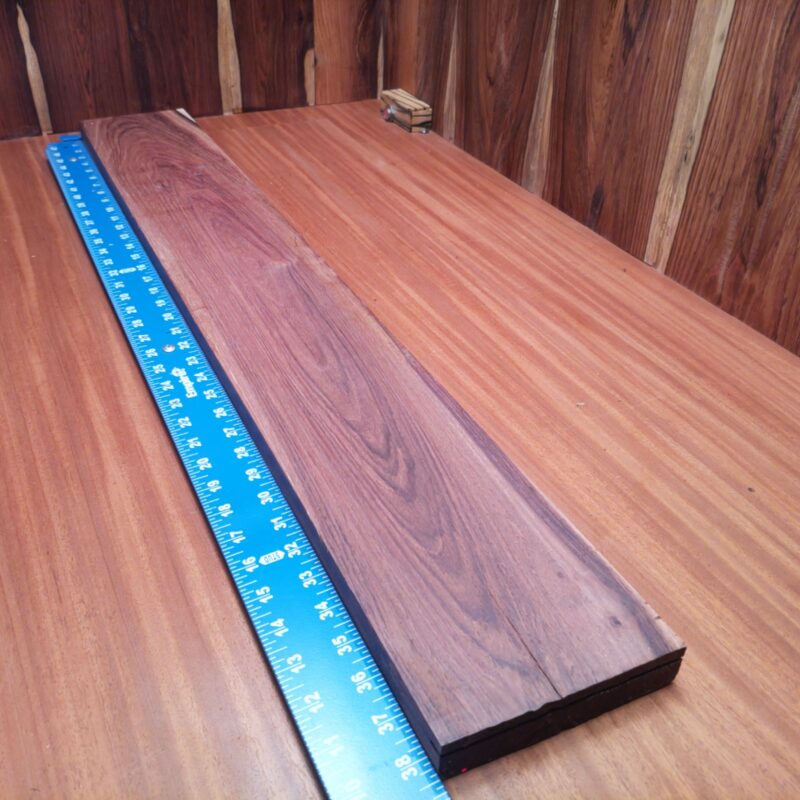 Honduran Rosewood 1.1" X 5.6" X 39.0" Wood Blank for Woodworking Projects - HRDL001235 6 With Honduran Rosewood G1, your decorative wall art will truly shine like the sun! Picture this: a unique charcuterie board that’s so beautiful even the cheese feels honored. Or how about a luxurious guitar neck that makes every strum sound like a dream? Finish it off with a stylish key holder, and you’ve got a modern home that sings! This piece of Honduran Rosewood measures 1.1 inches by 5.6 inches by 39.0 inches, offering a high-quality option for a variety of woodworking projects.