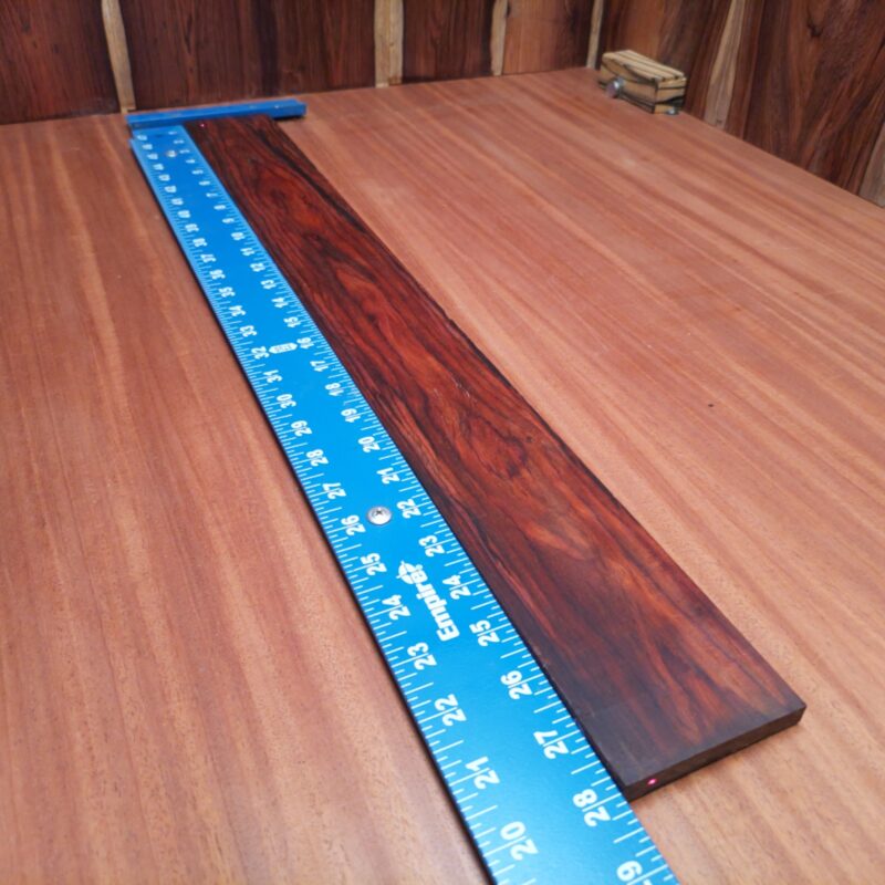 Unlock your creativity with this stylish Mexican Cocobolo bass fingerboard blank. Made from beautifully deep-toned wood, it offers excellent resonance and a smooth playing experience. Perfect for luthiers seeking quality materials, this blank promises to enhance your musical creations while standing out visually. Easy to shape and work with, it's the ideal foundation for your next custom instrument project. It is a Mexican Cocobolo Bass Flat Sawn fingerboard blank with dimensions of 28.0 x 3.0 x 0.3 inches.