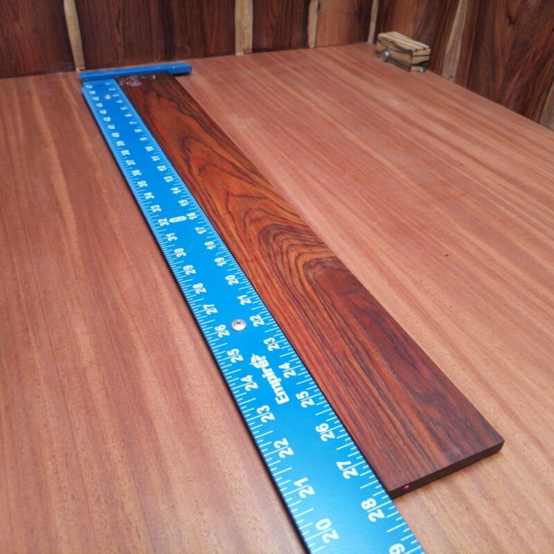 Unlock your creativity with our Mexican Cocobolo Bass blank. Ideal for luthiers, this premium quality wood ensures durability and striking aesthetics. With its rich, dark tones and fine grain patterns, your instrument will stand out while providing a warm sound. Perfect for crafting a unique bass guitar that pays homage to your artistry. Get ready to shape your vision with this fantastic fingerboard blank! It is a Mexican Cocobolo Bass Flat Sawn fingerboard blank with dimensions of 27.9 x 3.2 x 0.4 inches.
