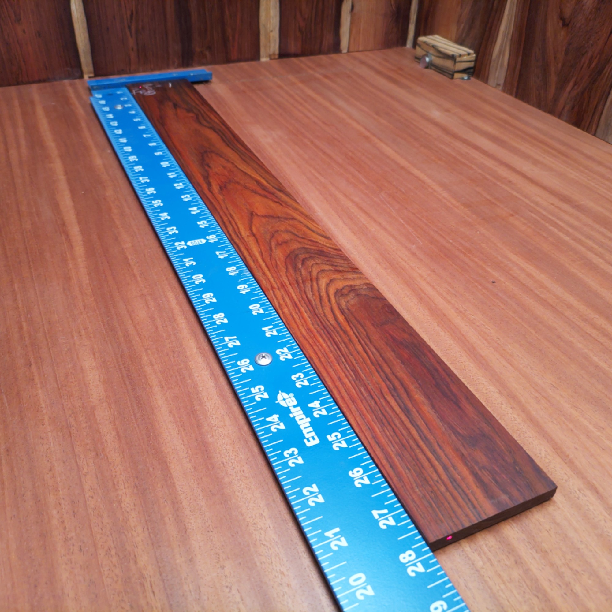 Mexican Cocobolo Bass Flat Sawn Fingerboard Blank 0.4" X 3.2" X 27.9" - MCBFBF000004 1 Unlock your creativity with our Mexican Cocobolo Bass blank. Ideal for luthiers, this premium quality wood ensures durability and striking aesthetics. With its rich, dark tones and fine grain patterns, your instrument will stand out while providing a warm sound. Perfect for crafting a unique bass guitar that pays homage to your artistry. Get ready to shape your vision with this fantastic fingerboard blank! It is a Mexican Cocobolo Bass Flat Sawn fingerboard blank with dimensions of 27.9 x 3.2 x 0.4 inches.