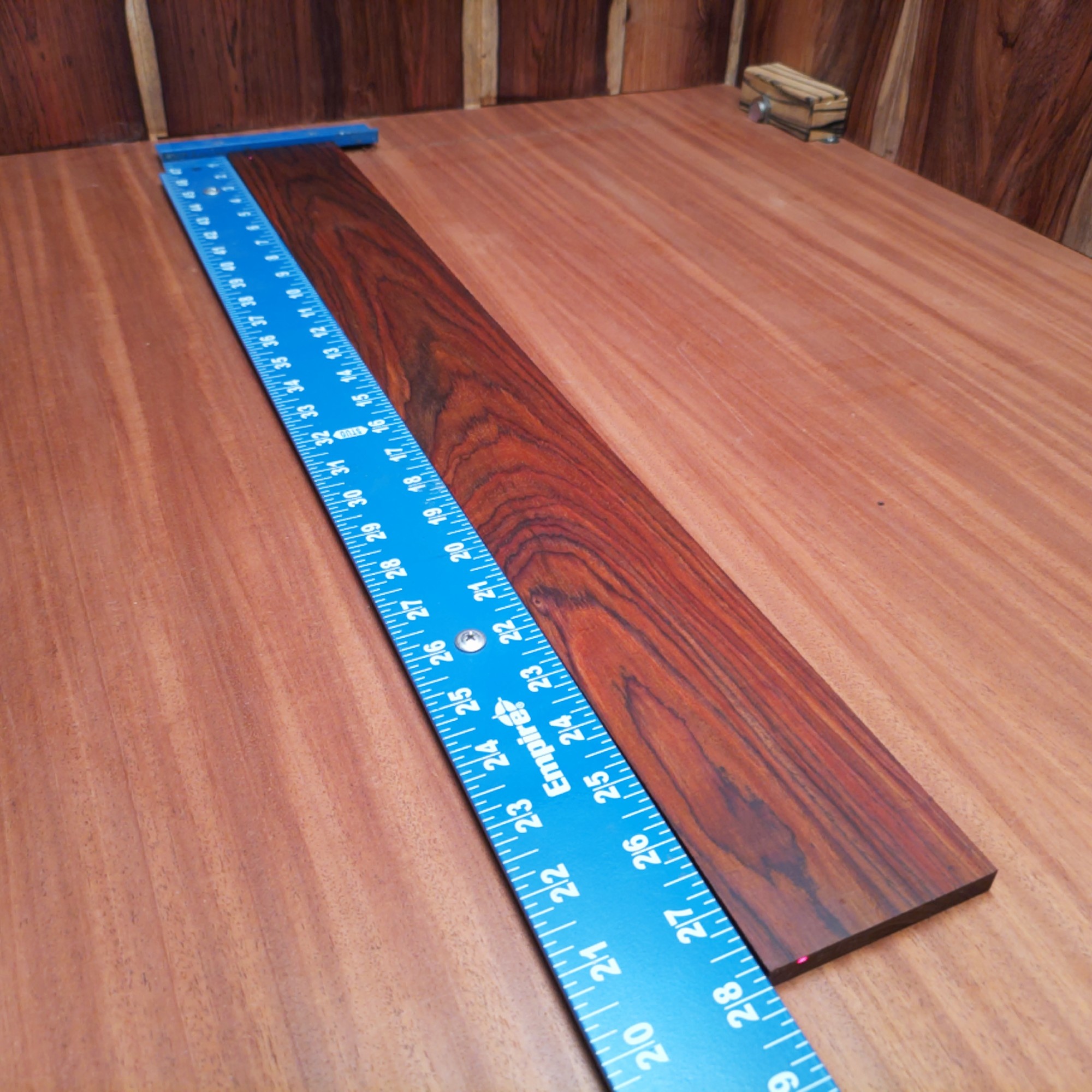 Mexican Cocobolo Bass Flat Sawn Fingerboard Blank 0.4" X 3.2" X 27.9" - MCBFBF000004 2 Unlock your creativity with our Mexican Cocobolo Bass blank. Ideal for luthiers, this premium quality wood ensures durability and striking aesthetics. With its rich, dark tones and fine grain patterns, your instrument will stand out while providing a warm sound. Perfect for crafting a unique bass guitar that pays homage to your artistry. Get ready to shape your vision with this fantastic fingerboard blank! It is a Mexican Cocobolo Bass Flat Sawn fingerboard blank with dimensions of 27.9 x 3.2 x 0.4 inches.