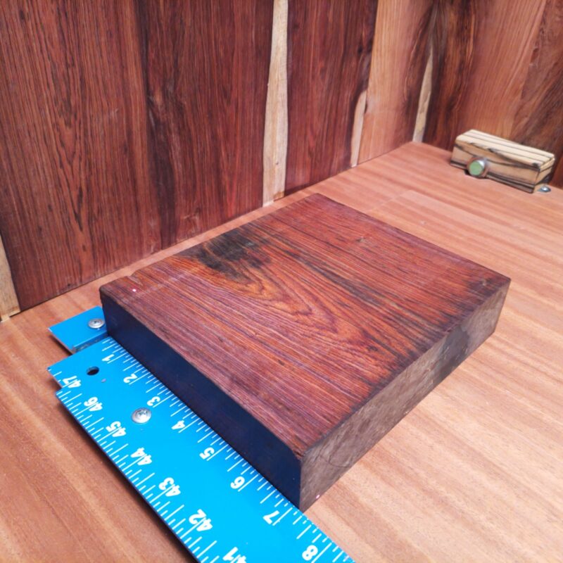 Discover the possibilities of Mexican Cocobolo with wonders like unique drawer pulls and handcrafted birdhouses. Elevate your game with high-end tablet stands and elegant serving trays that'll have dinner guests talking. With a bit of creativity, you could even make bespoke guitar necks or stylish wooden phone cases. Who knew wood could be so chique? This piece of Mexican Cocobolo measures 1.7 inches by 8.1 inches by 6.9 inches, offering a high-quality option for a variety of woodworking projects.