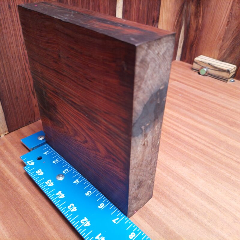 Discover the possibilities of Mexican Cocobolo with wonders like unique drawer pulls and handcrafted birdhouses. Elevate your game with high-end tablet stands and elegant serving trays that'll have dinner guests talking. With a bit of creativity, you could even make bespoke guitar necks or stylish wooden phone cases. Who knew wood could be so chique? This piece of Mexican Cocobolo measures 1.7 inches by 8.1 inches by 6.9 inches, offering a high-quality option for a variety of woodworking projects.