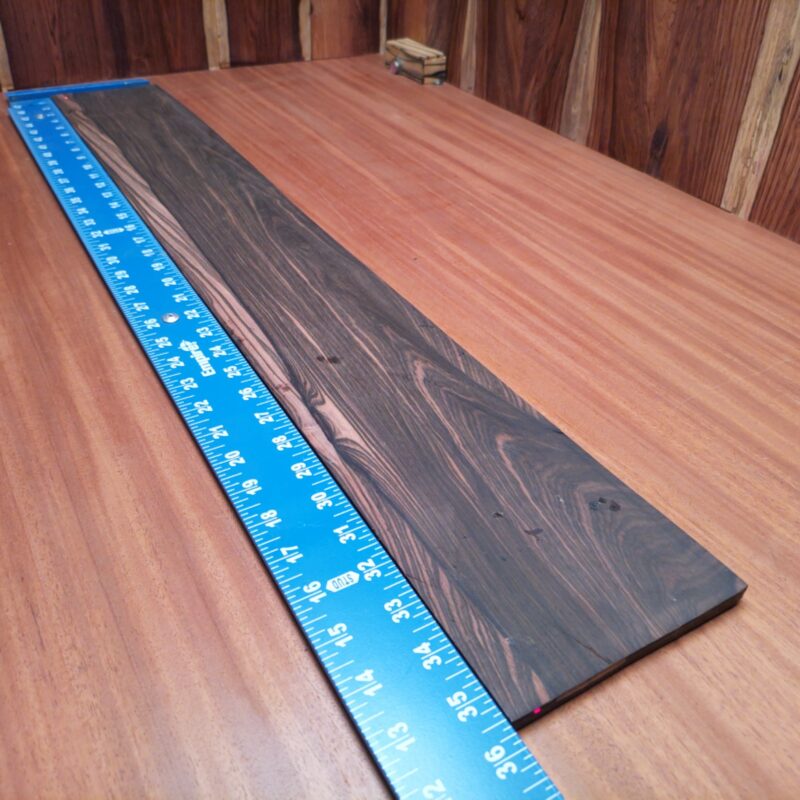 Mun Ebony Bass Quarter Sawn Fingerboard Blank 0.3" X 5.1" X 35.7" - MEBFBQ000011 3 Elevate your bass instrument game with our premium Mun Ebony blank. Perfectly quarter-sawn for optimal stability, this blank features deep hues and rich tones that enhance resonance. Ideal for luthiers looking to create stunning bass guitars or add a touch of luxury to their builds, it matches durability with aesthetic appeal. Grab yours and start shaping the sound of the next musical masterpiece! It is a Mun Ebony Bass Quarter Sawn fingerboard blank with dimensions of 35.7 x 5.1 x 0.3 inches.